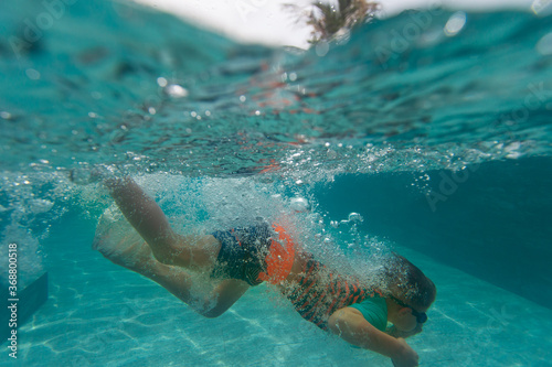 kid swimming underwater in pool, active kids