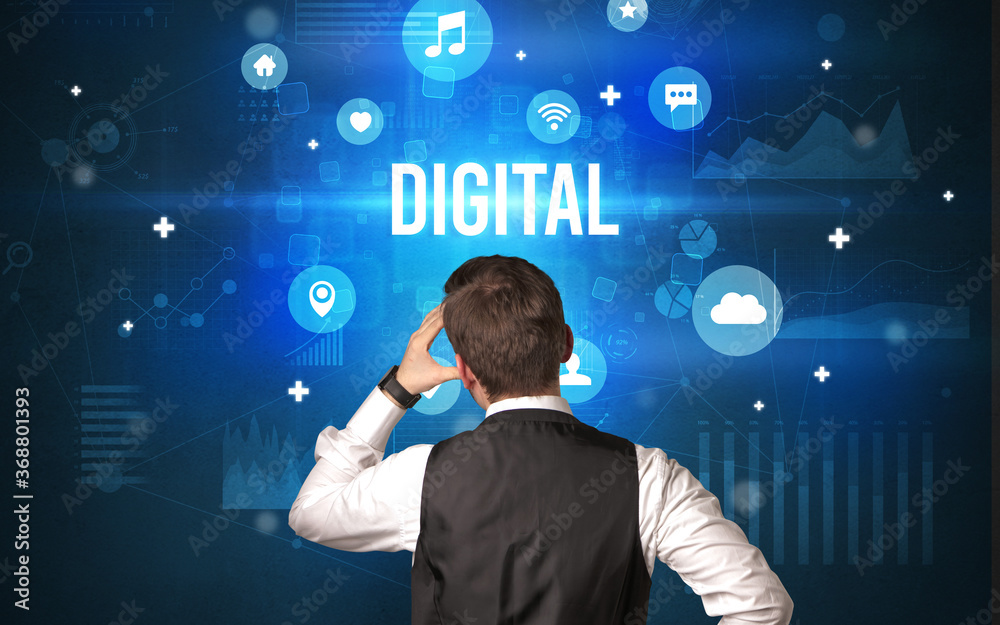 Rear view of a businessman with DIGITAL inscription, modern technology concept Rear view of a businessman with DIGITAL inscription, modern technology concept