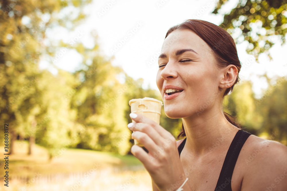 close-up. beautiful girl eating ice cream in the park close-up. beautiful girl eating ice cream in the park
