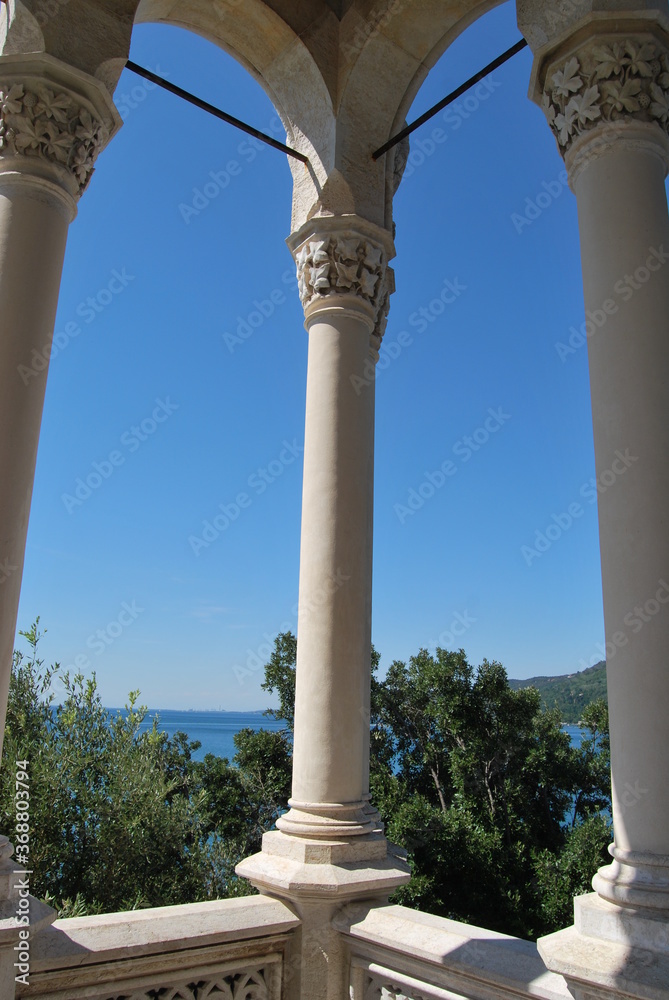 
sea ​​view through a stone arch with a central column