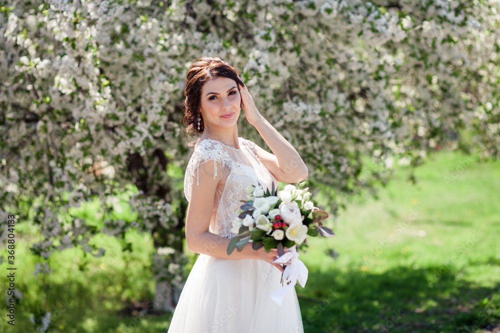 bride near white spring blooms