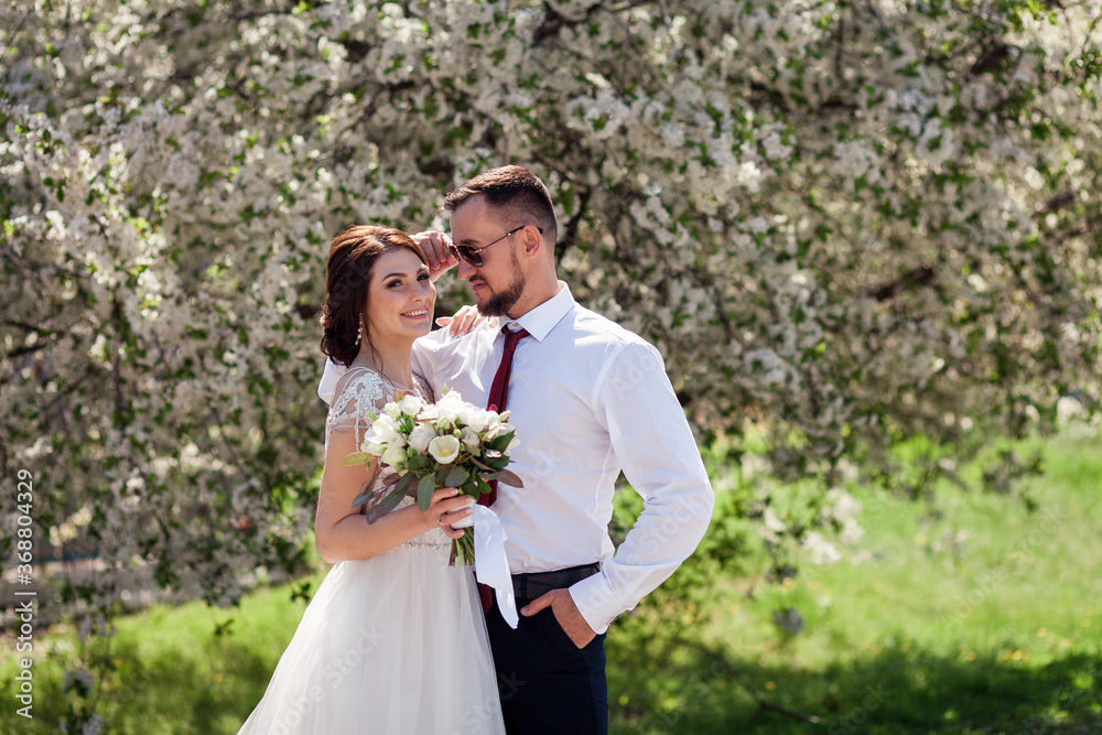 newlyweds near blooming trees newlyweds near blooming trees