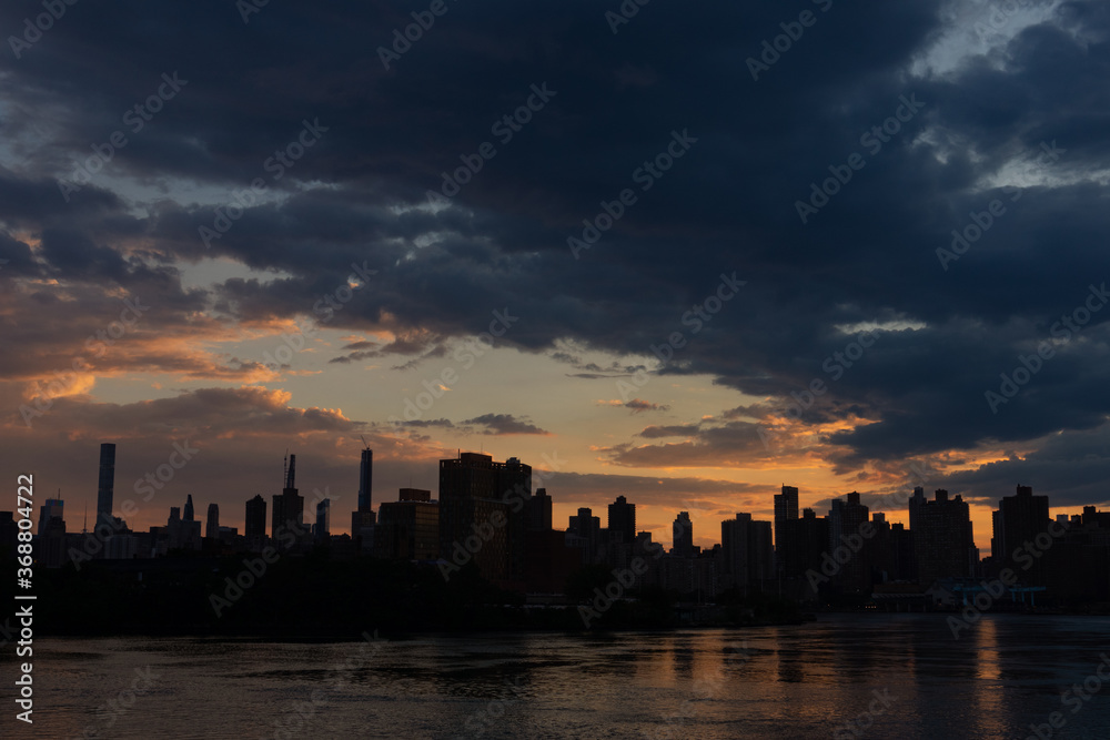 Dark Manhattan Skyline Silhouette along the East River during Sunset in New York City