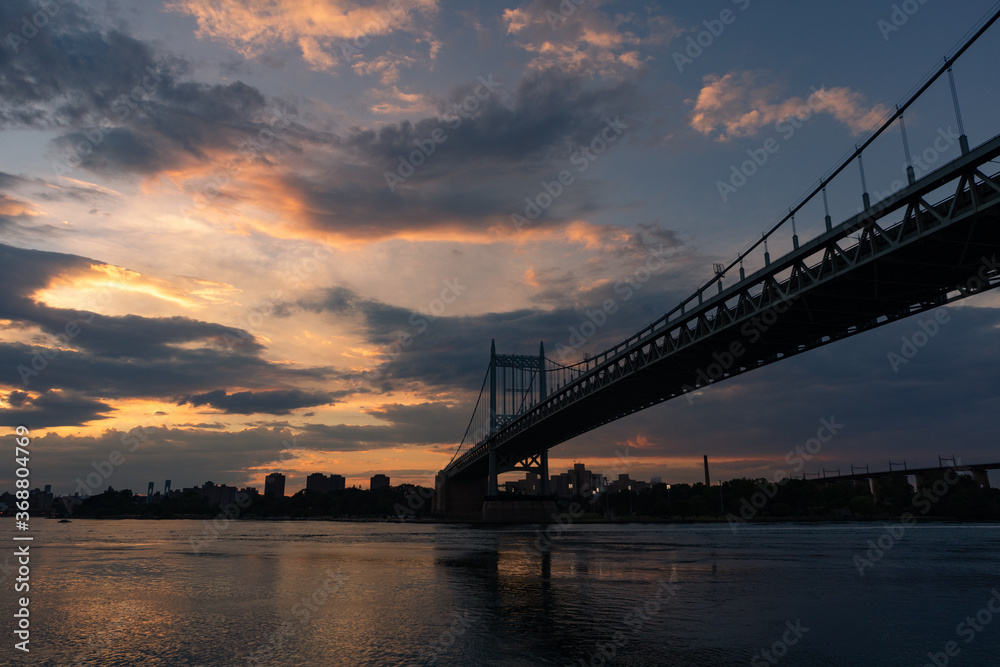 Triborough Bridge during a Beautiful Sunset over the East River connecting Astoria Queens New York to Wards and Randall's Island Triborough Bridge during a Beautiful Sunset over the East River connecting Astoria Queens New York to Wards and Randall's Island
