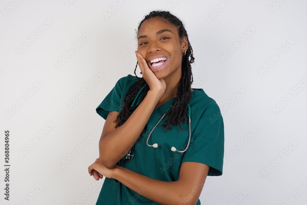 Surprise astonished beautiful doctor girl. Closeup portrait woman looking surprised in full disbelief wide open mouth with hand near face. Positive emotion facial expression body language. Surprise astonished beautiful doctor girl. Closeup portrait woman looking surprised in full disbelief wide open mouth with hand near face. Positive emotion facial expression body language.
