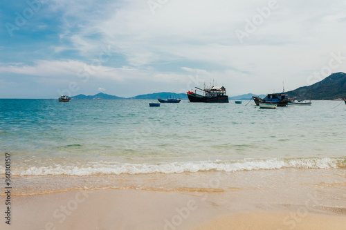 Fishing ships in Vietnam are anchored in a calm bay after a night out to sea