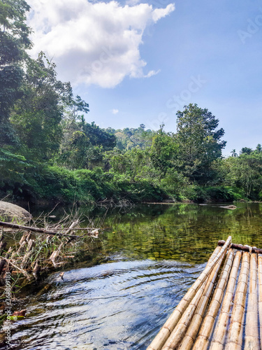 Walk on a bamboo raft along the coast on a summer day.