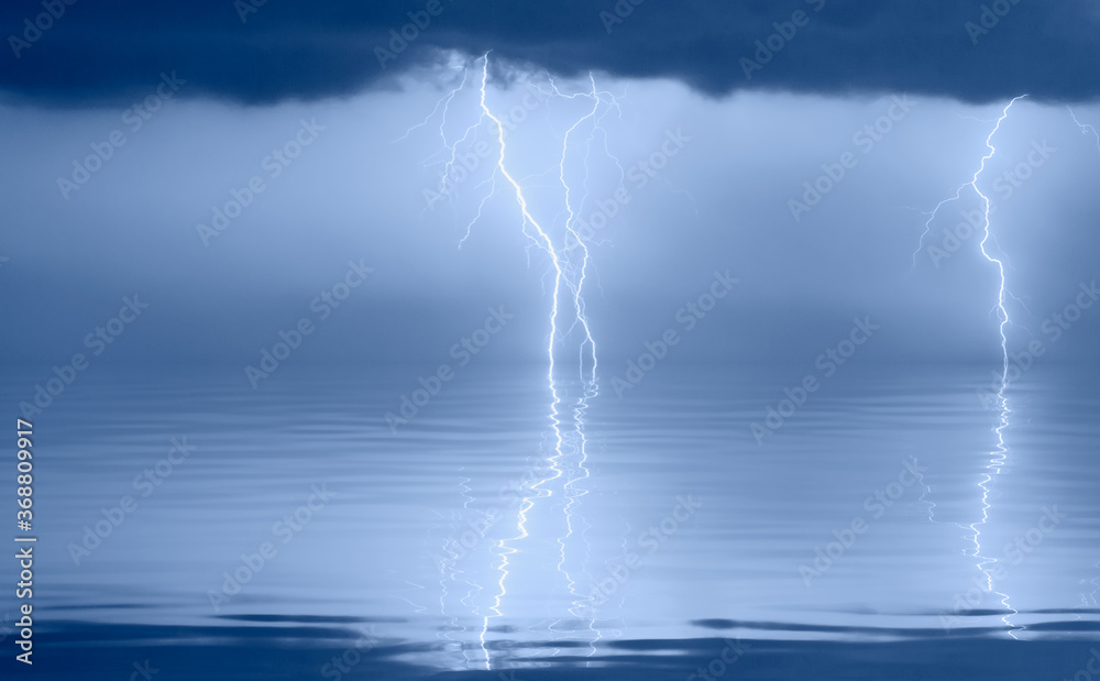 Tropical calm sea under amazing storm clouds with lightning Tropical calm sea under amazing storm clouds with lightning
