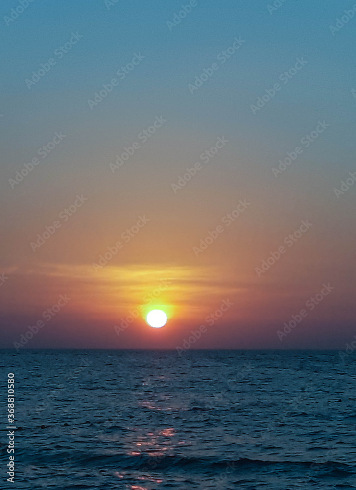 Sunset off the coast of Thailand on a warm evening. Summer, vacation, sea, beach.