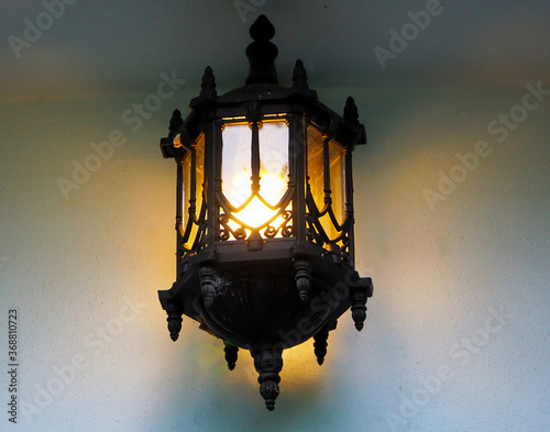 old classic lantern on the wall , vintage lantern , warm light 