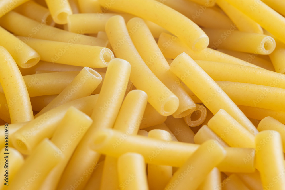 Macro shot pasta noodles texture. Macaroni background pattern. Top view. Dry pasta for cooking. Abstract italian macaroni background Macro shot pasta noodles texture. Macaroni background pattern. Top view. Dry pasta for cooking. Abstract italian macaroni background