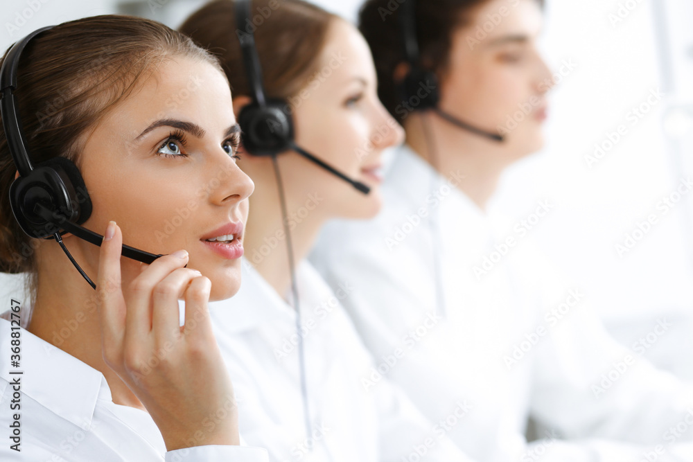 Call center. Beautiful young woman using headset and computer to help customers. Business concept Call center. Beautiful young woman using headset and computer to help customers. Business concept