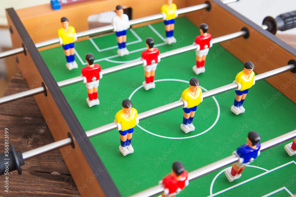 Table football game with yellow and red players and white goalkeeper. Table football game with yellow and red players and white goalkeeper.