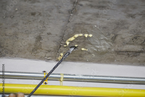 PU Foam injections for fixed water leakage under concrete floor or ceiling. Selective focus.