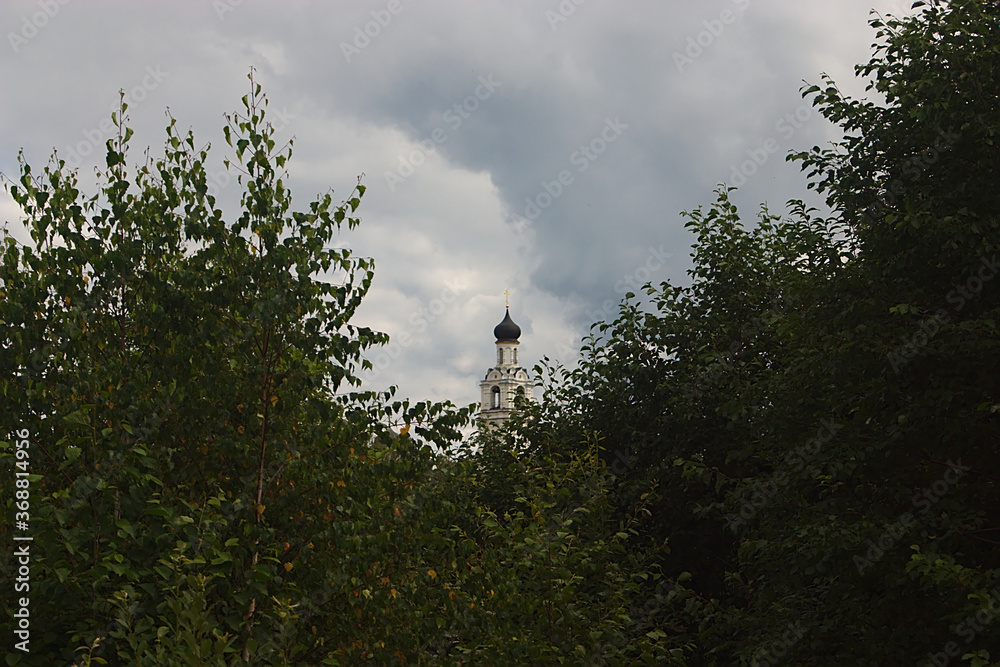 the Orthodox Church is visible behind the trees