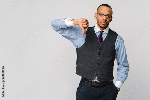 Photography young black businessman with a dissenting serious dislike expression with thumbs