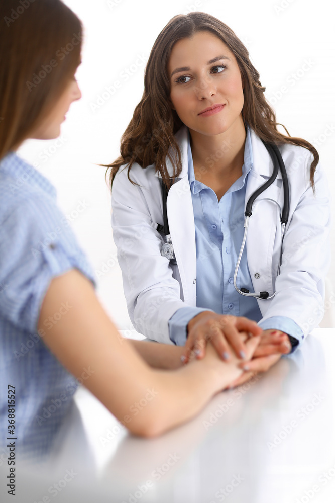 Doctor reassuring her female patient. Medical ethics and trust concept. Medicine and health care theme Doctor reassuring her female patient. Medical ethics and trust concept. Medicine and health care theme
