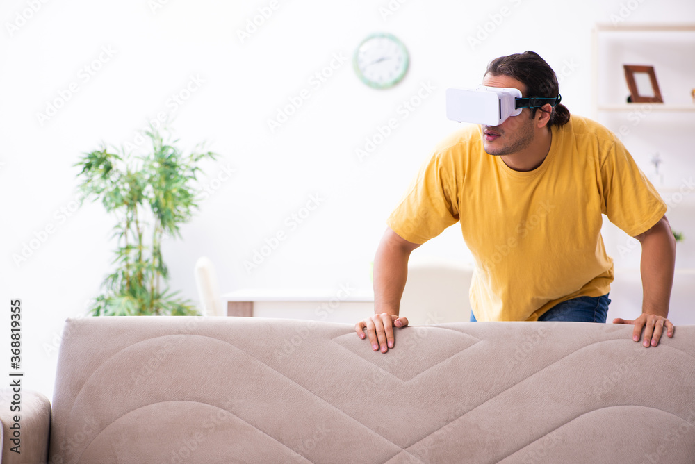 Young man with virtual reality glasses at home Young man with virtual reality glasses at home