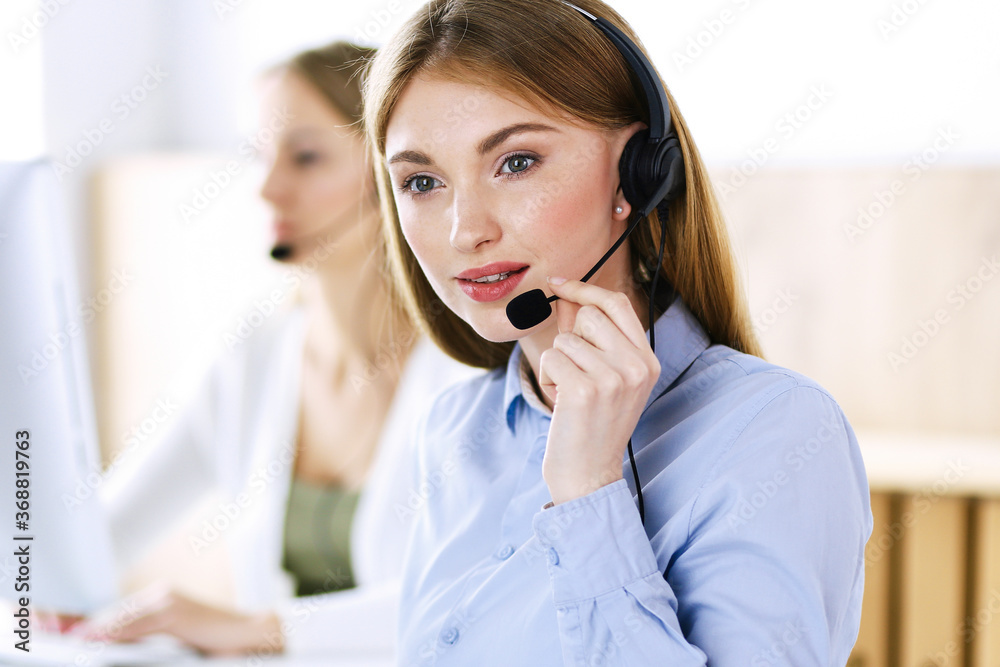 Portrait of call center operator at work. Group of people in a headset ready to help customers. Business concept Portrait of call center operator at work. Group of people in a headset ready to help customers. Business concept