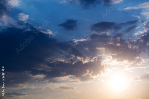 Large heavy clouds slowly float across the blue beautiful sky. Stunning landscape and view. sunset sky background .