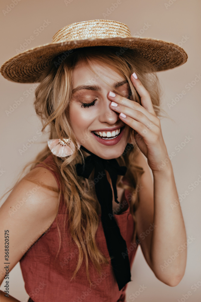 Pretty european girl posing in canotier. Studio shot of blonde young woman in straw hat. Pretty european girl posing in canotier. Studio shot of blonde young woman in straw hat.