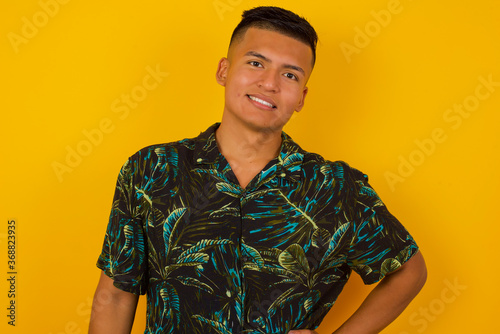Wallpaper Mural Studio shot of cheerful businessman keeps hand on hip, smiles broadly, anticipates for surprise prepared by friends on his birthday, isolated over gray background. Torontodigital.ca