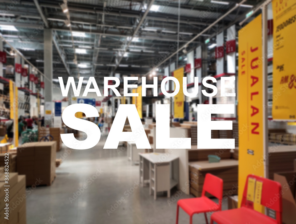 The word WAREHOUSE SALE is clearly written against the background of an image of a department store in a large warehouse. The image has been blurred. The word WAREHOUSE SALE is clearly written against the background of an image of a department store in a large warehouse. The image has been blurred.