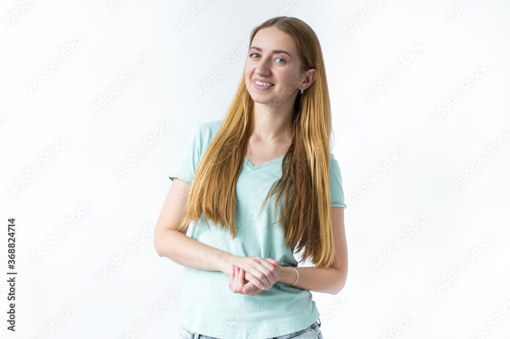 Portrait of smiling girl, hands pressed near her chest on white background Portrait of smiling girl, hands pressed near her chest on white background
