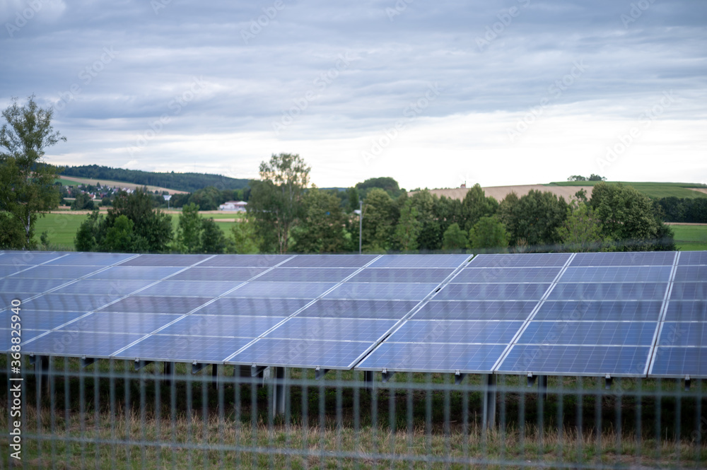 Beautiful sceenery of a little solar park in Bavaria, sourrounded by beautiful landscape in a little valley. Photograph was taken meanwhile sunset Beautiful sceenery of a little solar park in Bavaria, sourrounded by beautiful landscape in a little valley. Photograph was taken meanwhile sunset