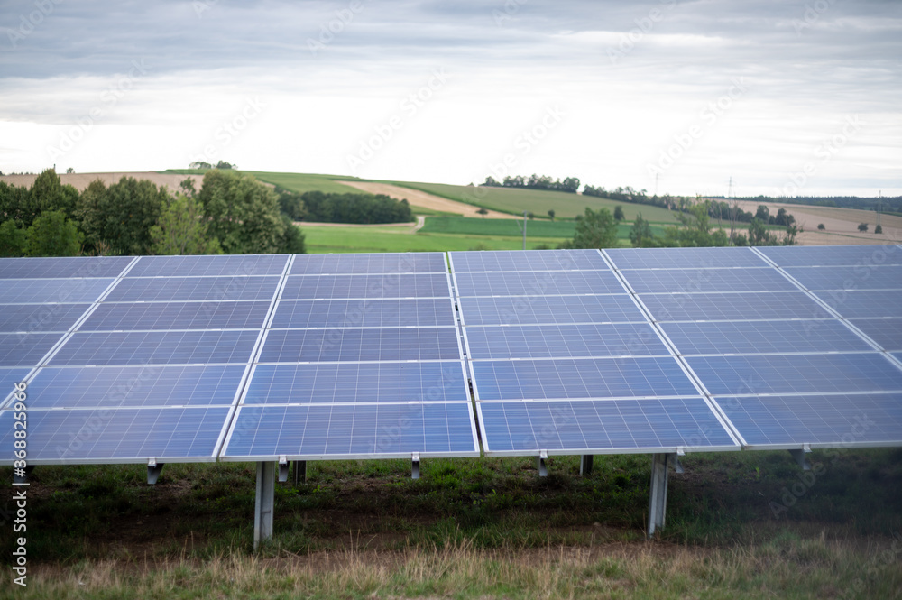 Beautiful sceenery of a little solar park in Bavaria, sourrounded by beautiful landscape in a little valley. Photograph was taken meanwhile sunset Beautiful sceenery of a little solar park in Bavaria, sourrounded by beautiful landscape in a little valley. Photograph was taken meanwhile sunset