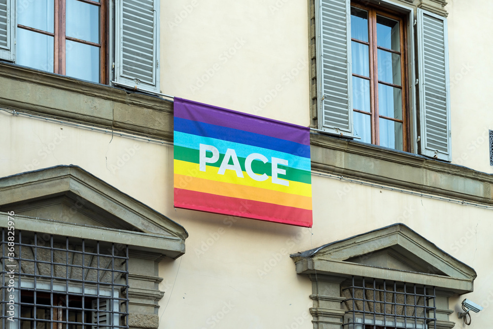 View of gay rainbow flag in the pride parade on a building. View of gay rainbow flag in the pride parade on a building.