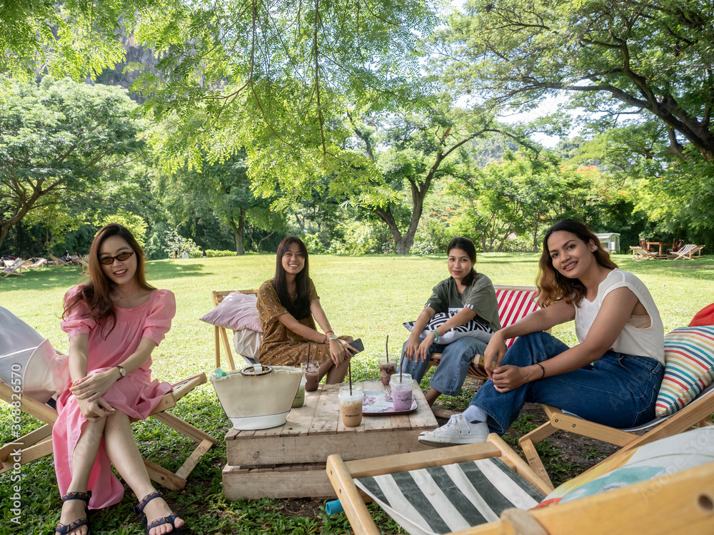people on canvas chair in garden having afternoon tea and relaxing. people on canvas chair in garden having afternoon tea and relaxing.