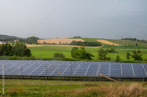 Beautiful sceenery of a little solar park in Bavaria, sourrounded by beautiful landscape in a little valley. Photograph was taken meanwhile sunset photo