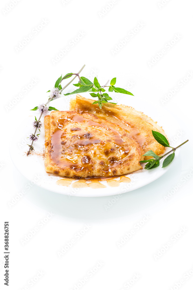 fried thin pancakes with sweet caramel in a plate fried thin pancakes with sweet caramel in a plate