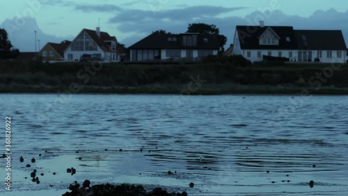 low shot of water with houses in the background