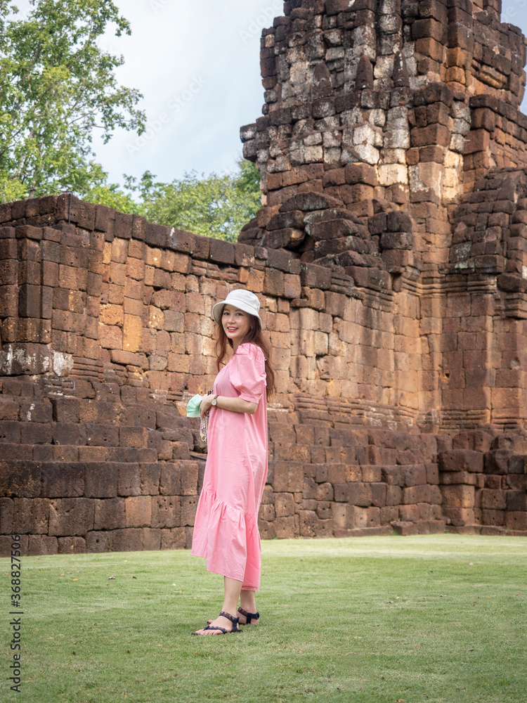 Asian woman tourist in pink dress with medical face mask at 