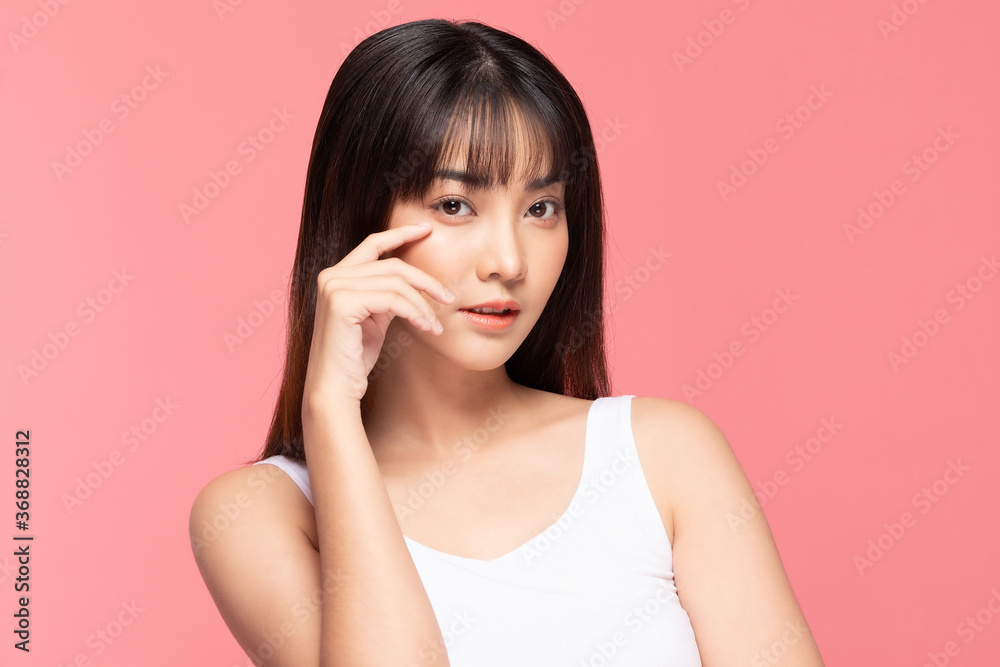 Young Beautiful Asian woman smile touching soft cheek with clean and fresh skin Happiness and cheerful with positive emotional,isolated on pink background,Beauty Cosmetics and spa Treatment Concept Young Beautiful Asian woman smile touching soft cheek with clean and fresh skin Happiness and cheerful with positive emotional,isolated on pink background,Beauty Cosmetics and spa Treatment Concept