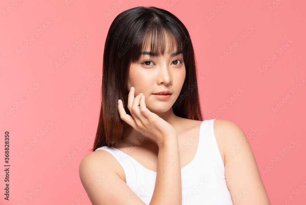Young Beautiful Asian woman smile touching soft cheek with clean and fresh skin Happiness and cheerful with positive emotional,isolated on pink background,Beauty Cosmetics and spa Treatment Concept Young Beautiful Asian woman smile touching soft cheek with clean and fresh skin Happiness and cheerful with positive emotional,isolated on pink background,Beauty Cosmetics and spa Treatment Concept
