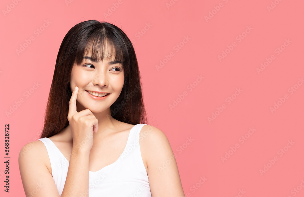 Beautiful Asian woman touching soft cheek smile with clean and fresh skin Happiness and cheerful with positive emotional,isolated on pink background,Beauty Cosmetics and spa Treatment Concept Beautiful Asian woman touching soft cheek smile with clean and fresh skin Happiness and cheerful with positive emotional,isolated on pink background,Beauty Cosmetics and spa Treatment Concept