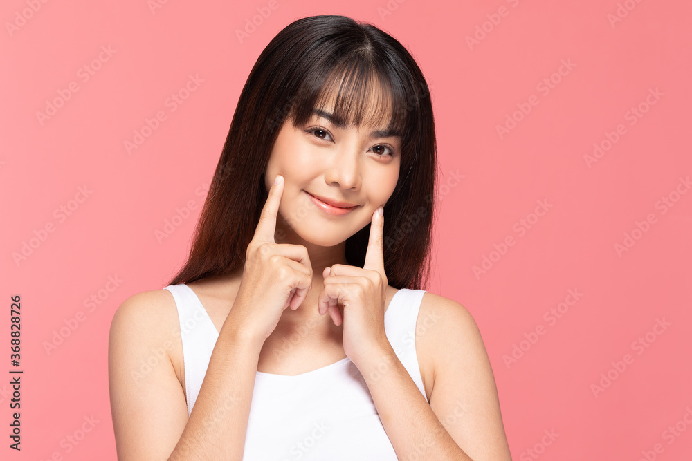 Beautiful Asian woman touching soft cheek smile with clean and fresh skin Happiness and cheerful with positive emotional,isolated on pink background,Beauty Cosmetics and spa Treatment Concept Beautiful Asian woman touching soft cheek smile with clean and fresh skin Happiness and cheerful with positive emotional,isolated on pink background,Beauty Cosmetics and spa Treatment Concept