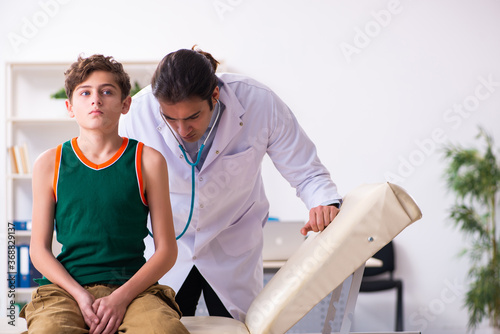 Sick boy visiting young male doctor pediatrician