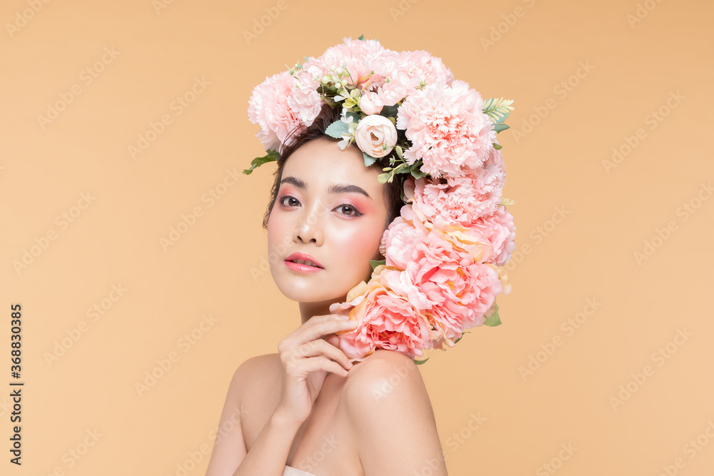 Beauty Asian young woman with big bouquet flowers on head smile