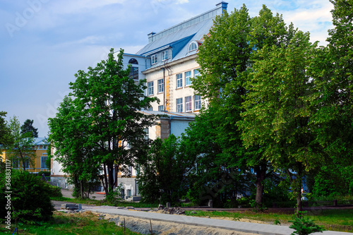 Facade of historic building of public school in downtown in summer