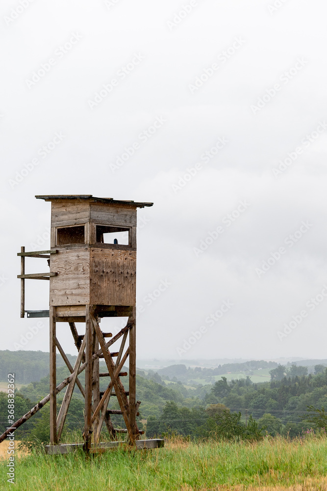 Lonley deerstand for hunters and Hunting on beautyful orange field. This capture was taken 16th of July in Harburg (Schwaben), Bavaria, Germany