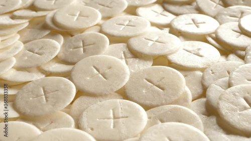 communion hosts sacramental breads turning round rotating flat lay top view photo