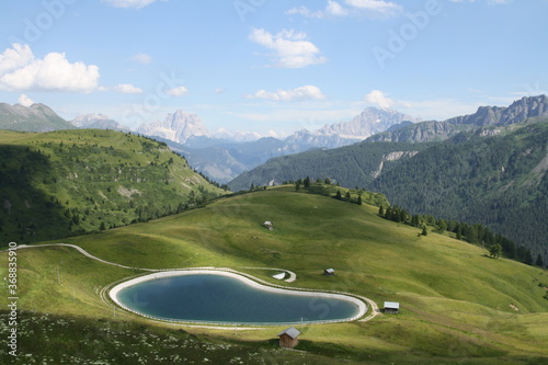 panoramic view of the meadows, lakes and mountains of the sella group in alta badia