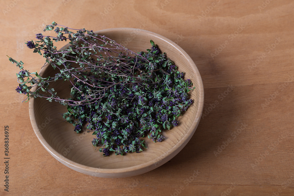 Raw Organic Thyme in a wooden Bowl on wooden table. Top view. Raw Organic Thyme in a wooden Bowl on wooden table. Top view.