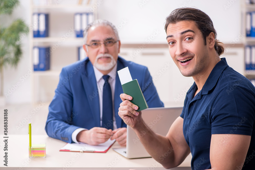 Young man visiting embassy for visa application Young man visiting embassy for visa application
