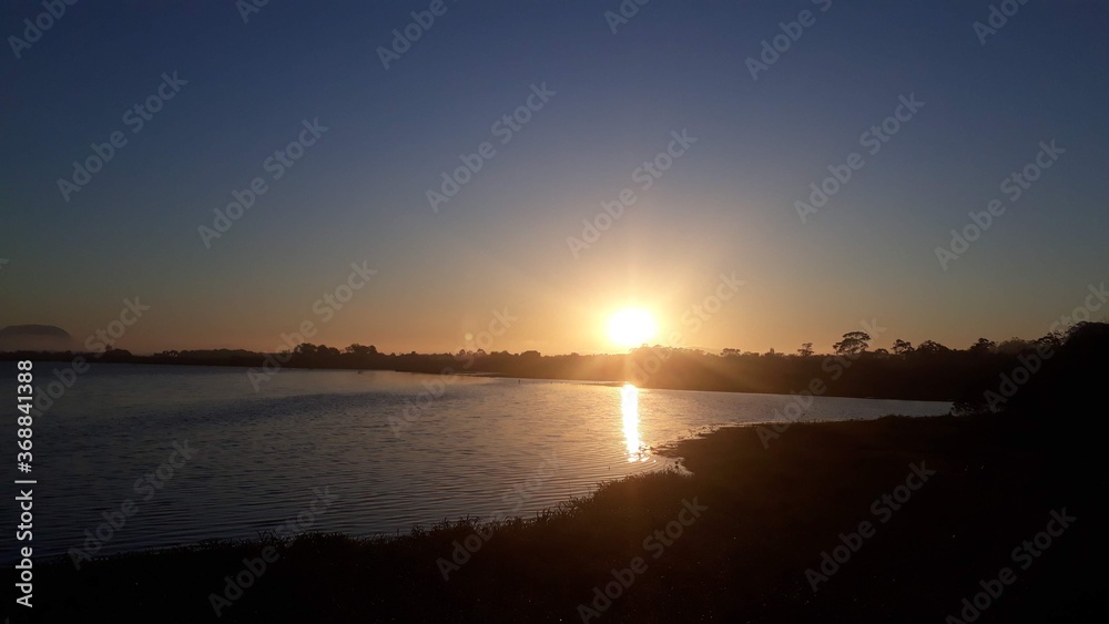 Naklejka premium sunset over the river