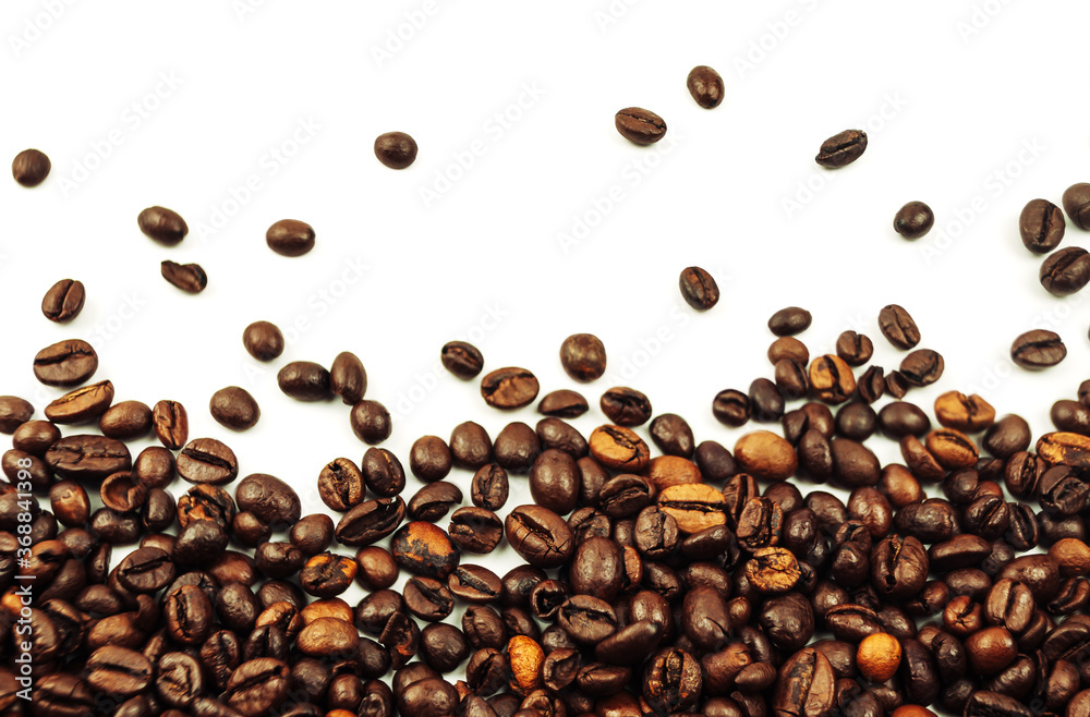 coffee beans scattered on a white background. aromatic arabica on a background with copy space. mockup